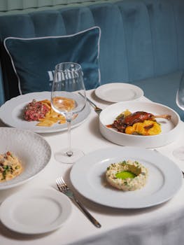 pexels photo 14459158 14459158 1 Assorted gourmet dishes elegantly plated on a restaurant table, offering a fine dining experience.