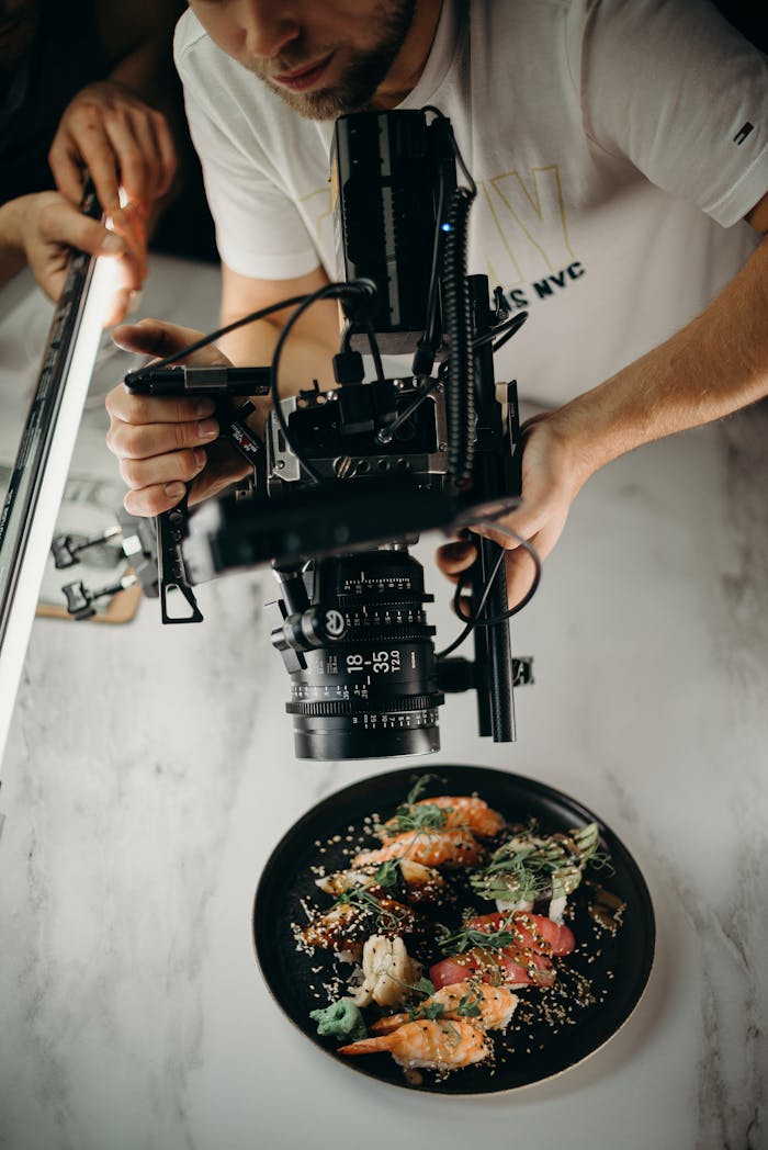 gallery-1 Photographer capturing a gourmet dish with high-end camera equipment from above.